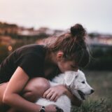 dog kiss and hug by woman